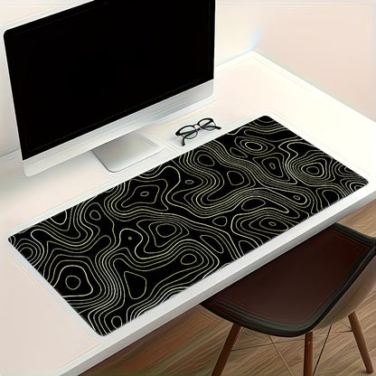 Desk with a black and gold patterned mouse pad, computer monitor, and glasses.