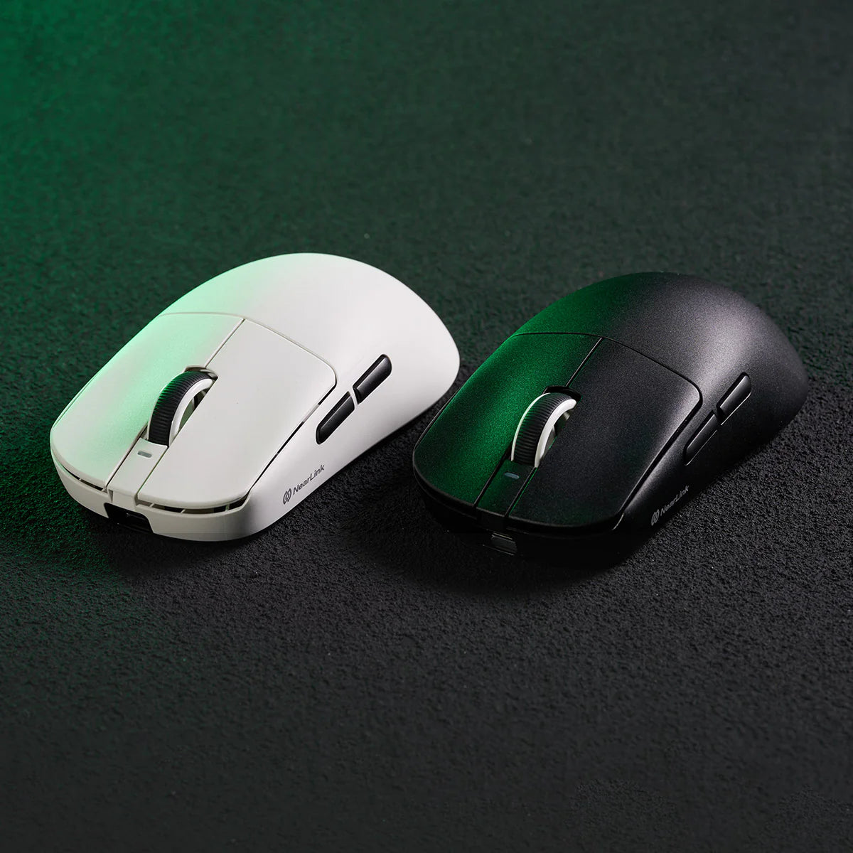 Two gaming mice, one white and one black, on a dark surface.