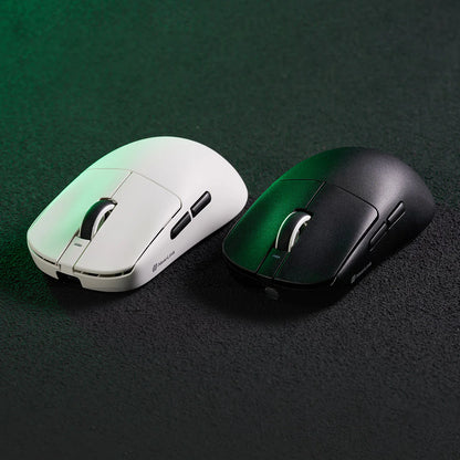 Two gaming mice, one white and one black, on a dark surface.